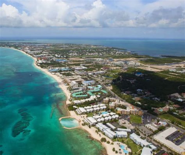 Why do businesses move to the Cayman Islands?